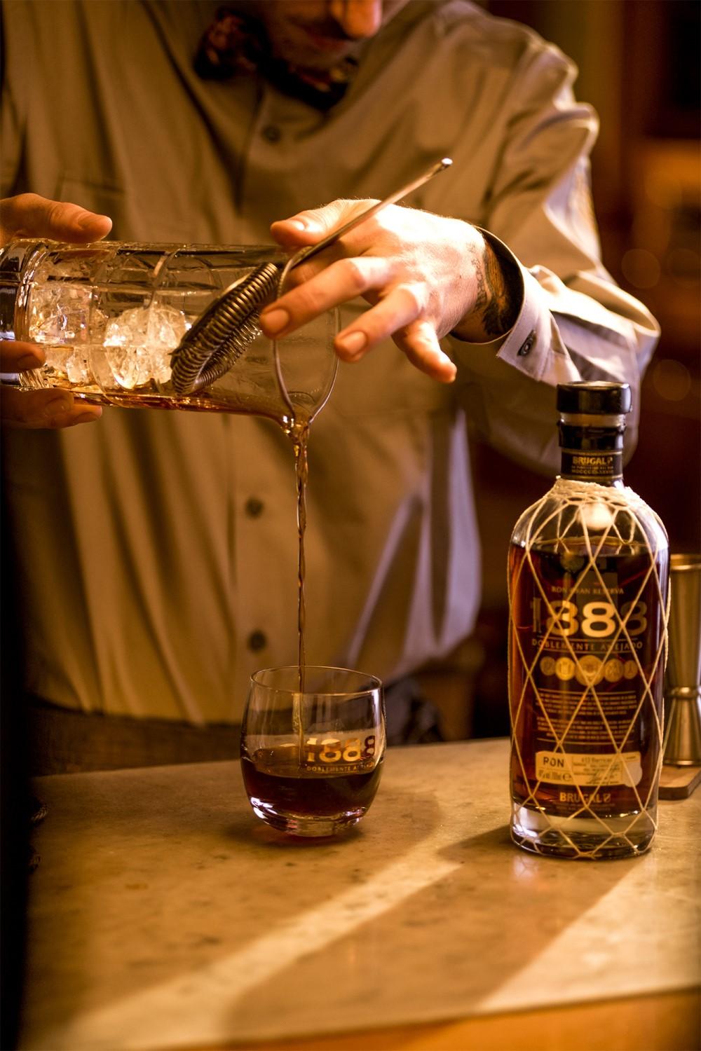 bartender pouring Brugal 1888 rum cocktail